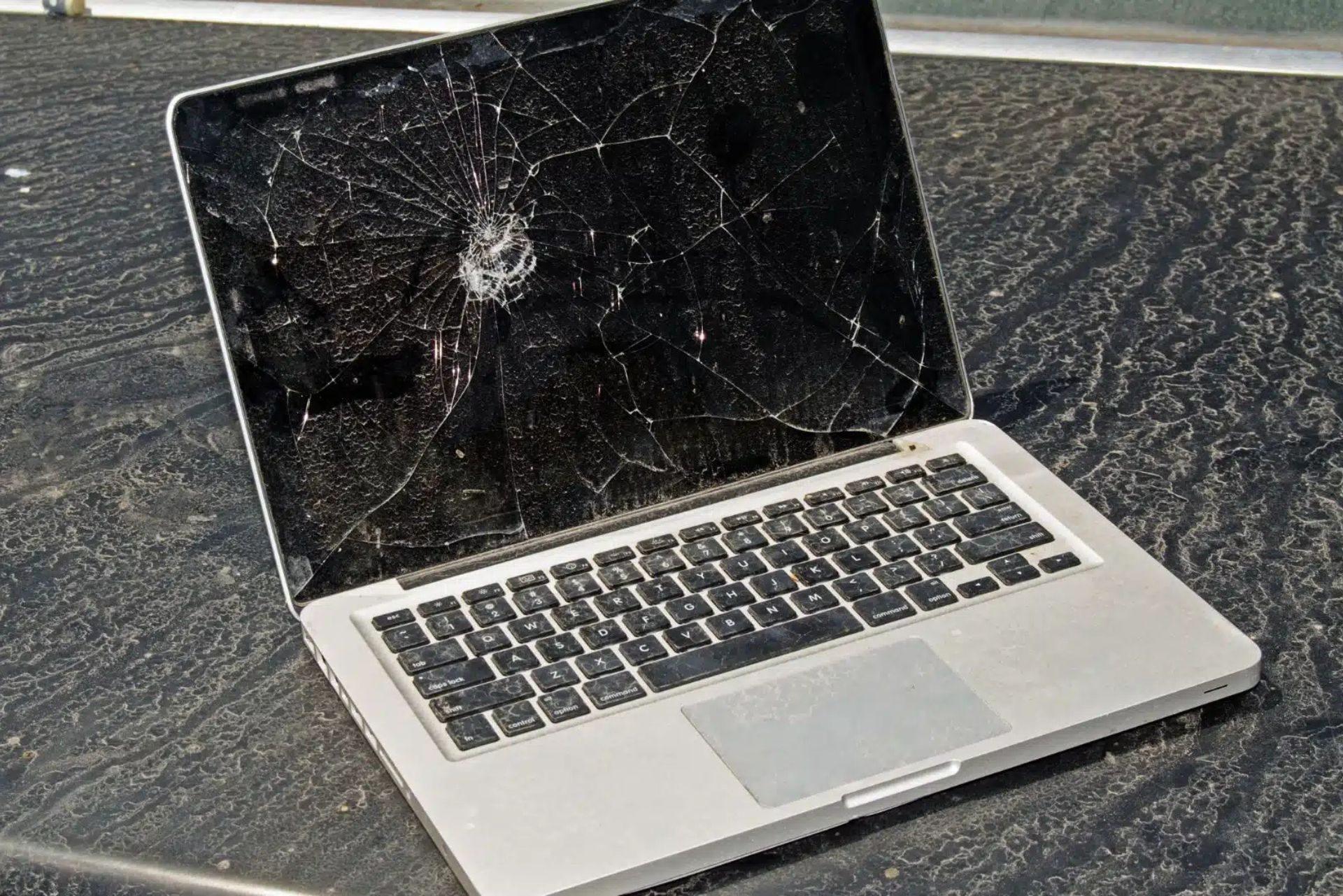 MacBook Pro with a badly cracked screen on a workbench, the kind of damaged Apple laptop brought to the Kiwi Data Recovery lab in Auckland for data recovery